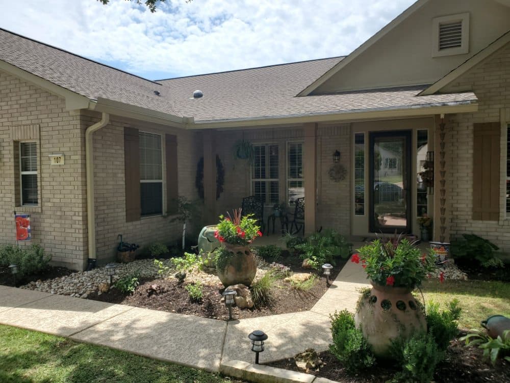 Beautiful brick home with professionally installed gutters by Jobe Gutter Services