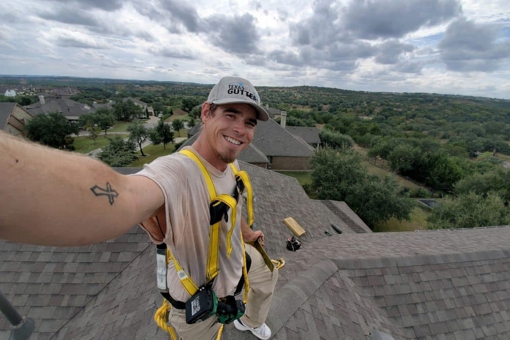 Jobe Gutter Services technician on rooftop in Texas